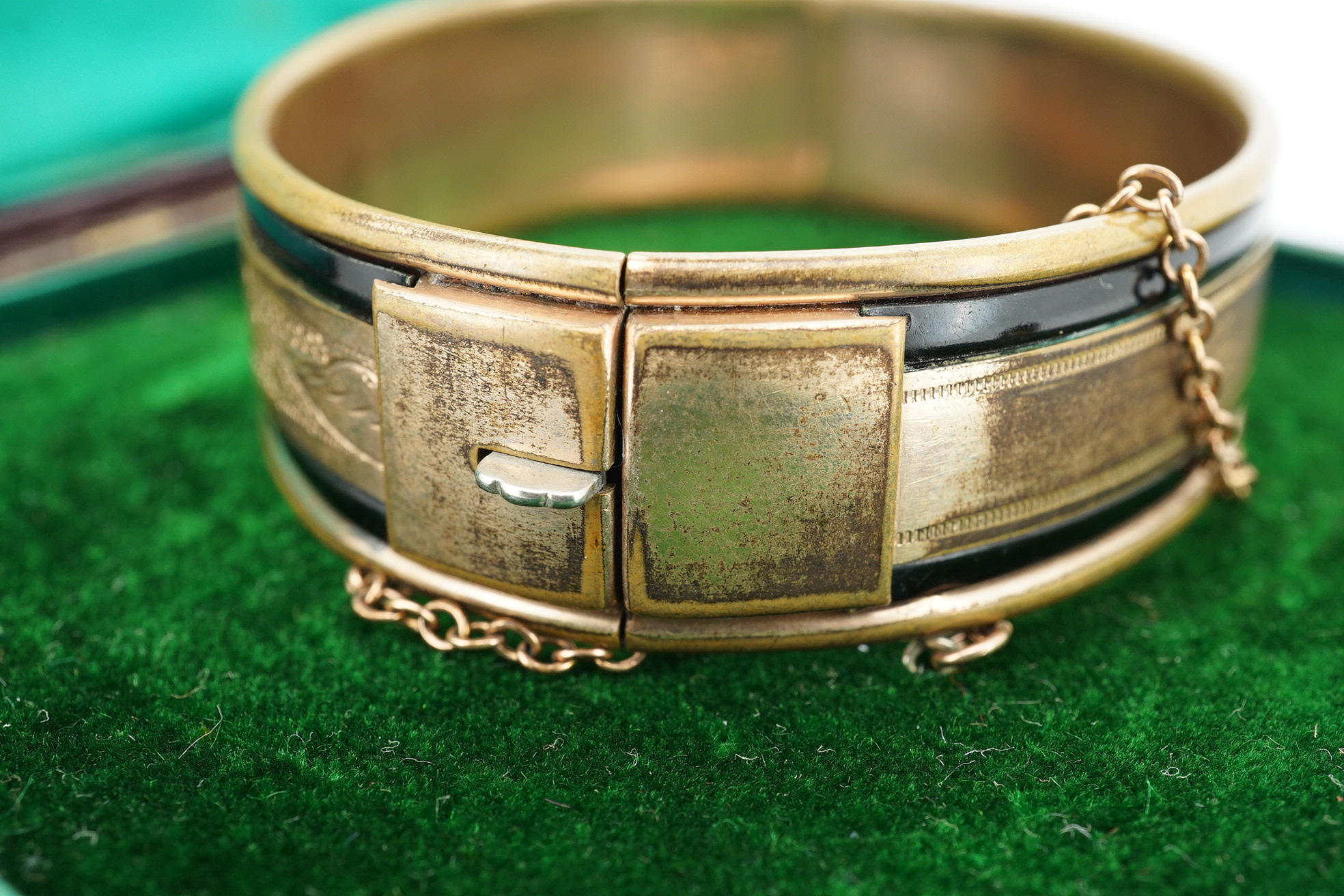 An Edwardian 9ct gold, and gypsy set ruby and diamond set hinged bangle, gross 11.4 grams, together with a gilt metal hinged bangle. Condition - poor.